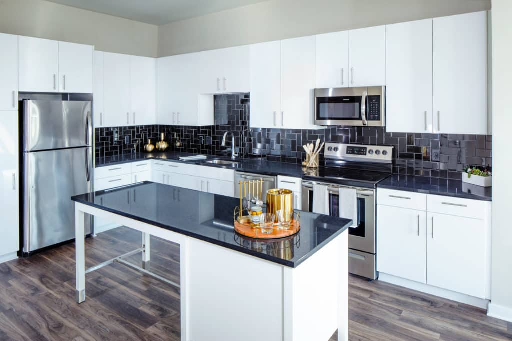 Apartments Fairfax VA-Scout on the Circle Kitchen with Modern Lighting, Matching Stainless Steel Appliances, and a Dining Area