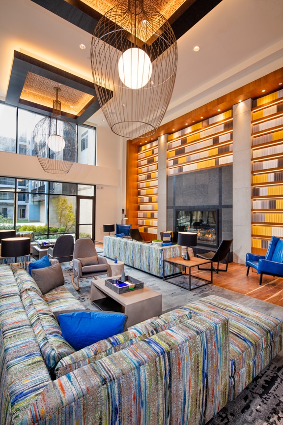 lounge with sofa, seating areas, and fireplace - scout on the circle fairfax va luxury apartments