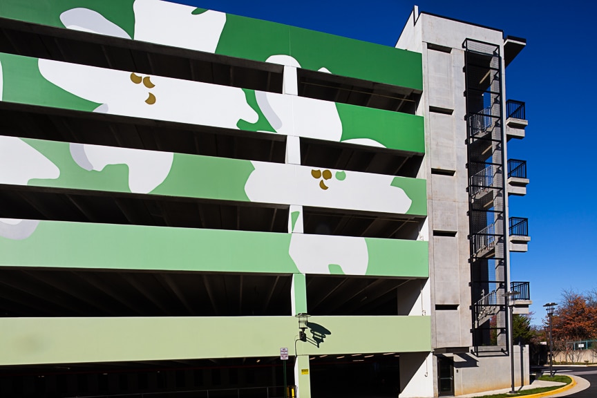 Large green flower mural on the parking garage at scout Fairfax luxury apartments