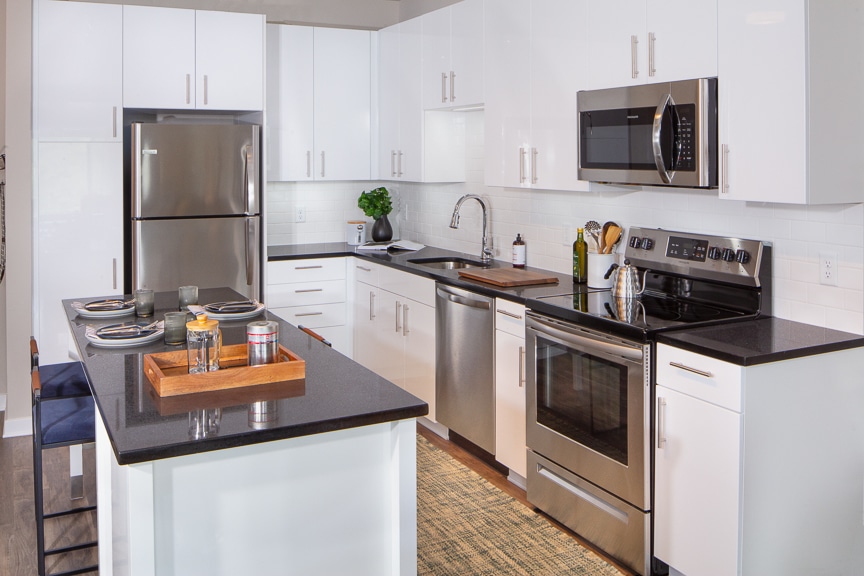 Apartments Fairfax VA - Scout on the Circle - Spacious Kitchen with a Kitchen Island, Stainless Steel Appliances, and White Cabinetry