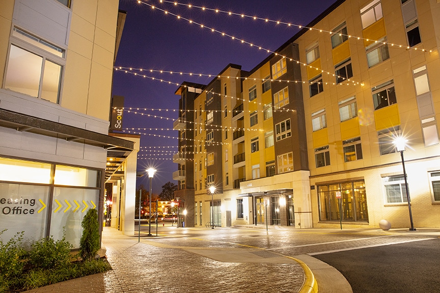 Exterior night view with string lights at scout Fairfax luxury apartments
