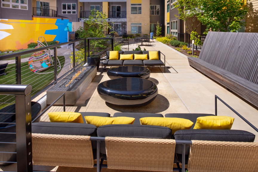 courtyard with social seating, firepit and views of balconies at scout on the circle luxury fairfax apartments